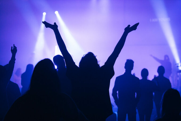 Girl Worshipping with hands in the air