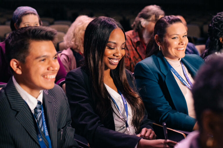 Students Smiling and taking notes in class